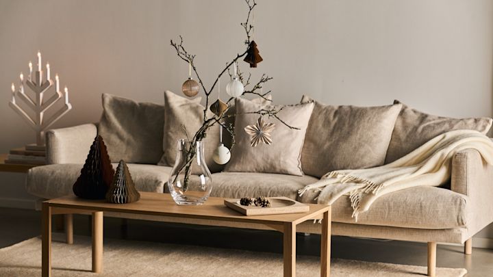 Moderne og minimalistisk julepynt med Nobili-graner i olivengrønn fra Kähler i vinduskarmen.