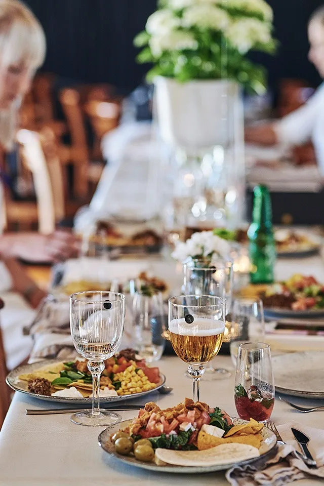 Sommerfestens gjester spiser tacoen som serveres, drikke serveres i Spectra vinglass fra House Doctor.