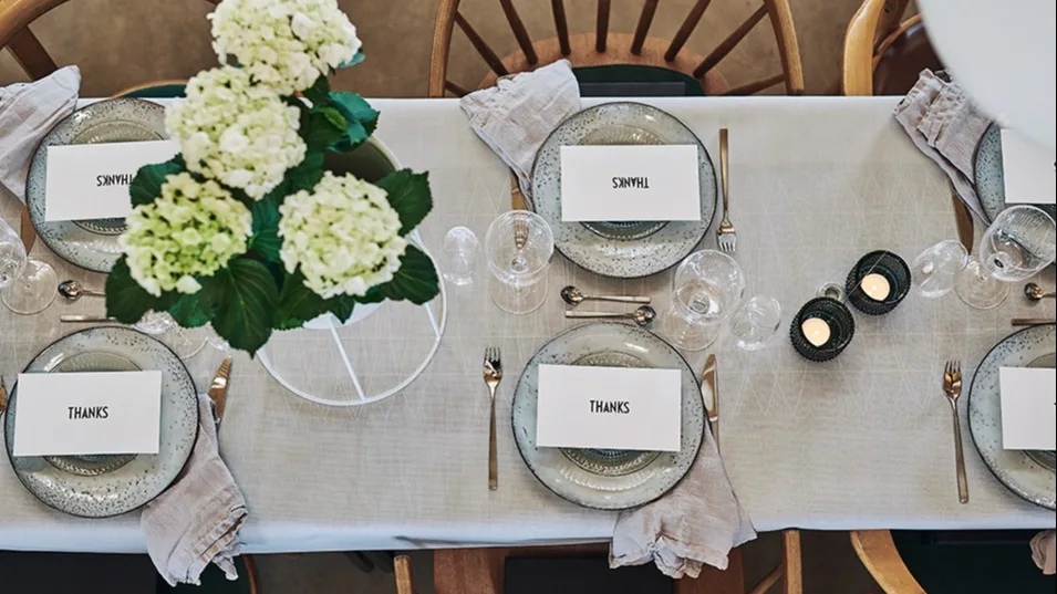 Bordet er dekket til mange med Nordic Sand-tallerkener fra Broste Copenhagen og bestikk fra Gense for en borddekking i kalde farger på sommerfesten.