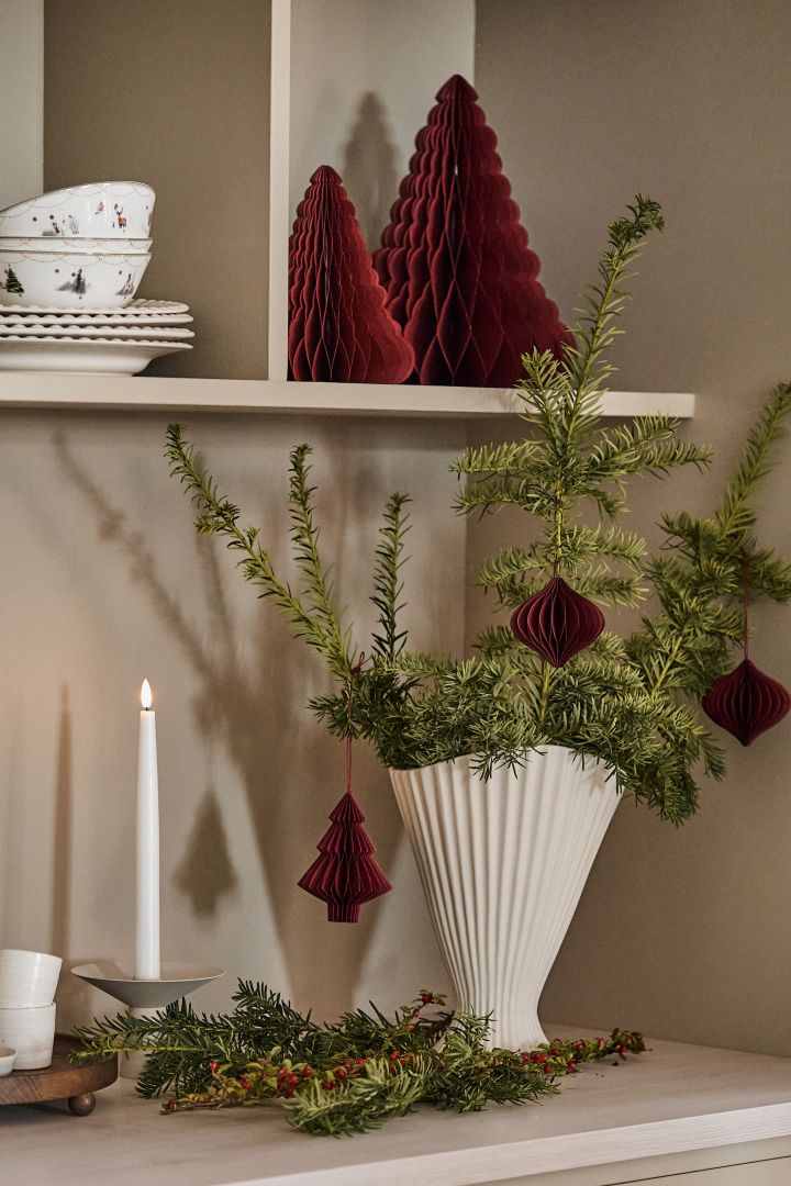 Pynt en vase som Fountain fra ferm LIVING med granbar for å skape julestemning i hjemmet sammen med juletrepynt fra Scandi Living.