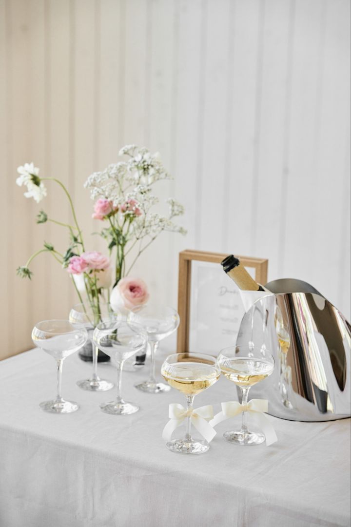 Denne unike bryllupsideen er ideell for utendørs bryllup. Her ser du en drinkstasjon med vinkjøler og et sett med More Coupe glass fra Orrefors. 